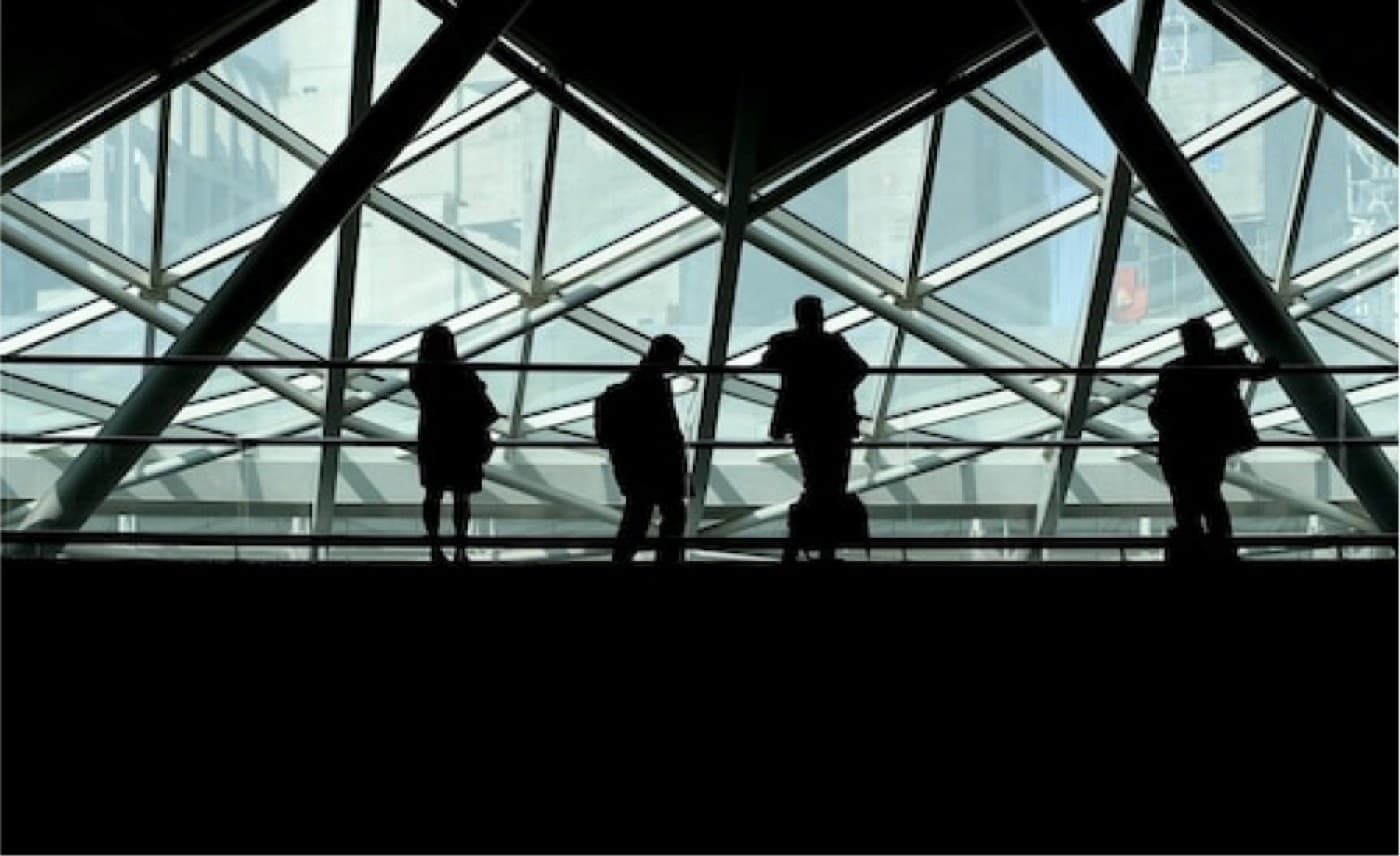 Visitors looking out across the city from beneath a glazed atrium roof